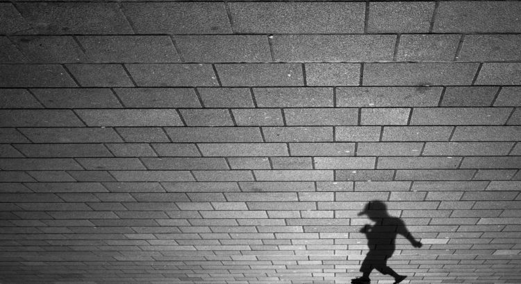 Child's shadow on brick wall